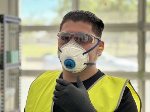 Tradie wearing O2 Disposable P2 Valved Respirator at Your Safety Factory