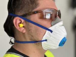 Tradie wearing O2 Disposable P2 Valved Respirator at Your Safety Factory