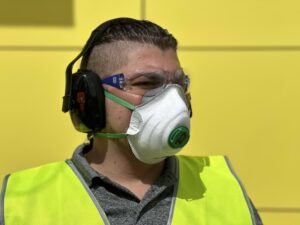 Tradie wearing O2 Moulded-Fit Disposable P2 Respirator at Your Safety Factory